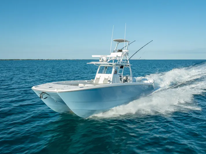  Yacht Photos Pics 2023 Invincible 37 Catamaran cruising on open water, showcasing sleek design and performance.