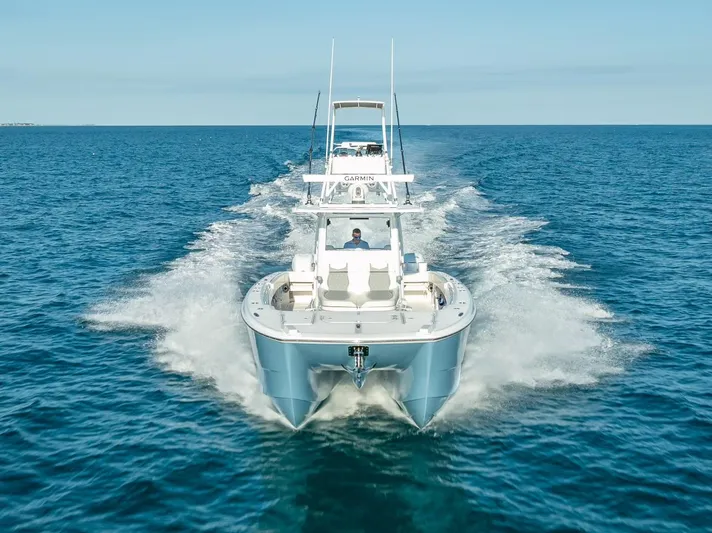  Yacht Photos Pics 2023 Invincible 37 Catamaran cruising on open blue ocean waters.