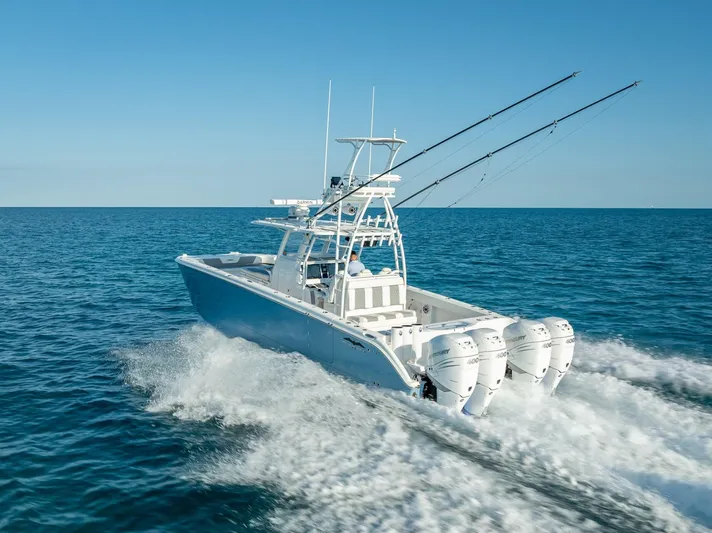  Yacht Photos Pics 2023 Invincible 37 Catamaran cruising on open sea with triple outboard engines.