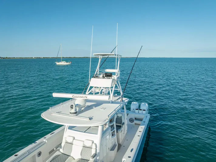  Yacht Photos Pics 2023 Invincible 37 Catamaran on open water, featuring advanced Garmin navigation.