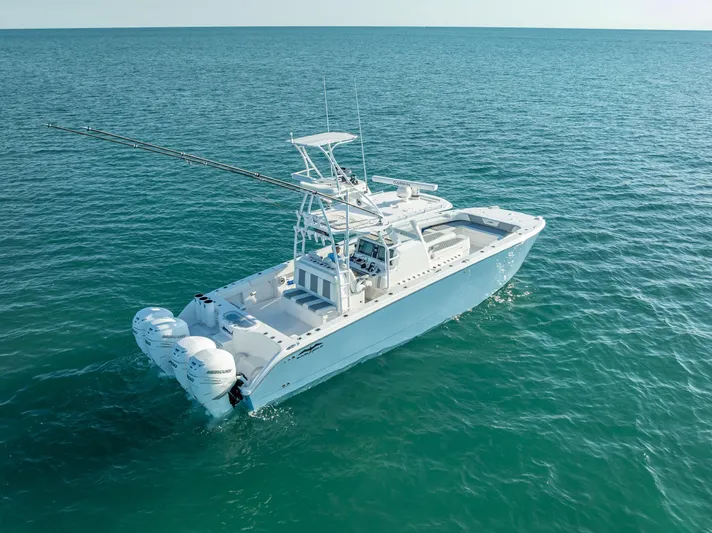  Yacht Photos Pics 2023 Invincible 37 Catamaran on open sea, showcasing sleek design and powerful engines.