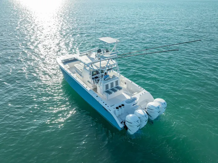  Yacht Photos Pics 2023 Invincible 37 Catamaran on serene ocean waters, showcasing sleek design and powerful engines.