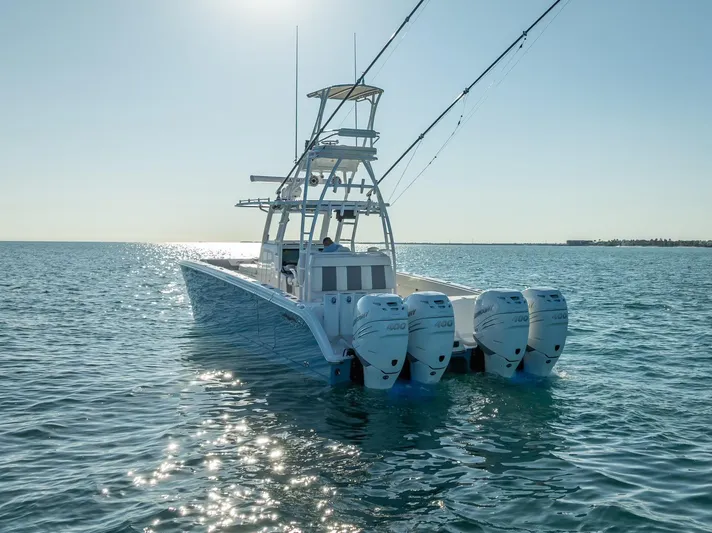  Yacht Photos Pics 2023 Invincible 37 Catamaran with four engines on open water.