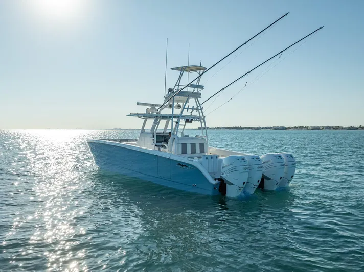  Yacht Photos Pics 2023 Invincible 37 Catamaran on calm ocean waters under clear sky.