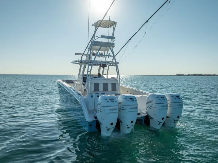  Yacht Photos Pics 2023 Invincible 37 Catamaran with four engines on open water, rear view.