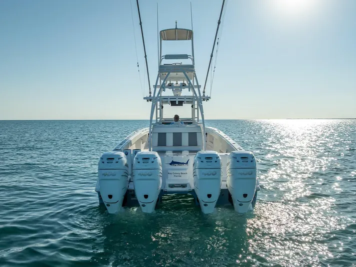  Yacht Photos Pics 2023 Invincible 37 Catamaran on open water, rear view with four engines.