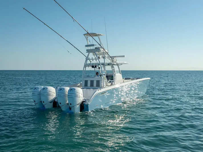 Yacht Photos Pics 2023 Invincible 37 Catamaran on open water, featuring triple outboard engines.