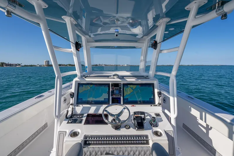  Yacht Photos Pics 2023 Invincible 37 Catamaran helm with advanced navigation systems on open water.