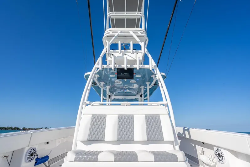  Yacht Photos Pics 2023 Invincible 37 Catamaran with sleek seating and advanced navigation system against clear blue sky.