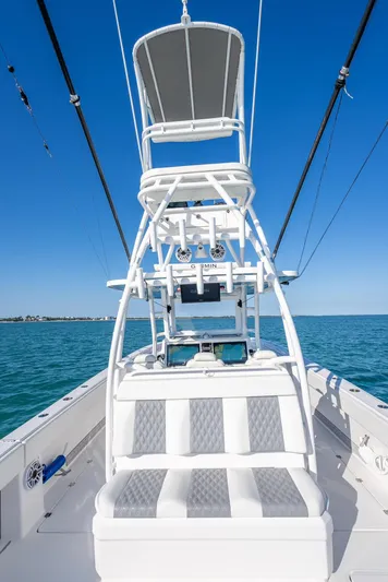  Yacht Photos Pics 2023 Invincible 37 Catamaran with tower, on calm blue waters under clear sky.