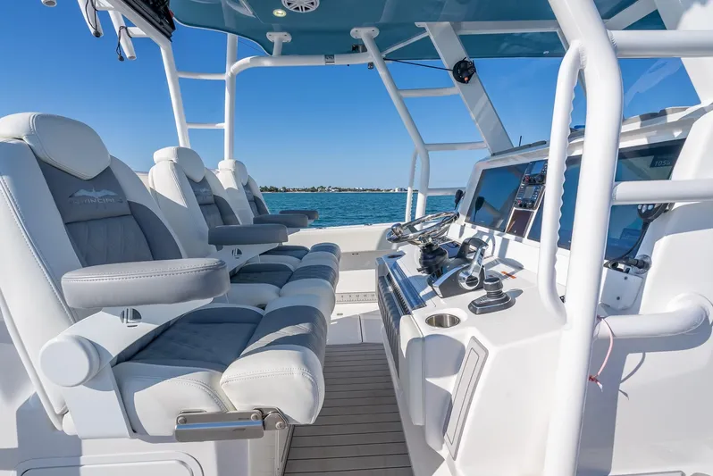  Yacht Photos Pics 2023 Invincible 37 Catamaran interior with modern seating and control panel, ocean view.