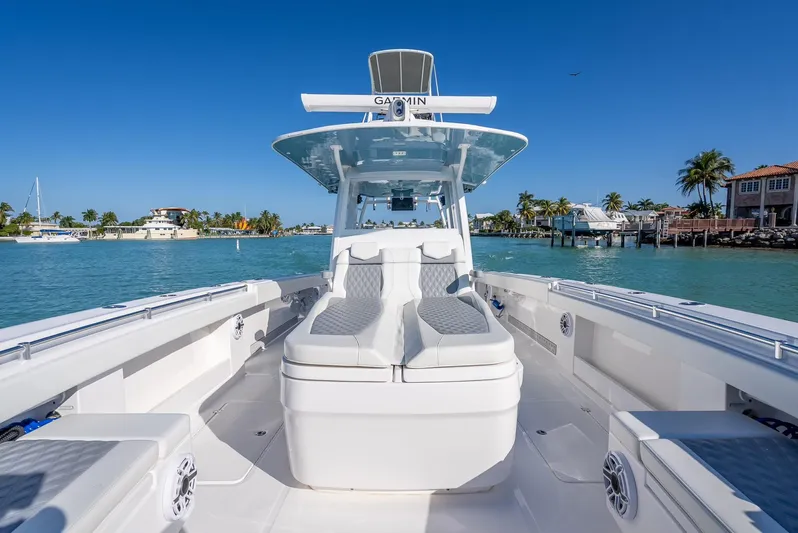  Yacht Photos Pics 2023 Invincible 37 Catamaran on clear blue water, showcasing sleek design and spacious deck.