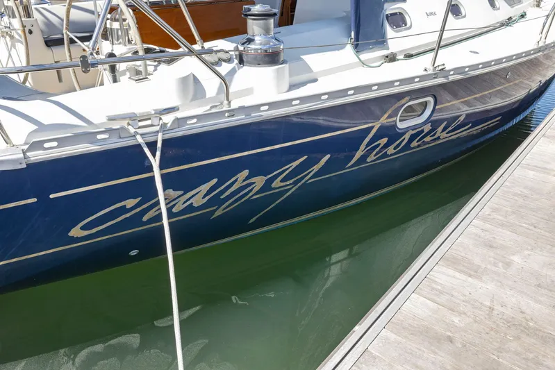 Crazy Horse Yacht Photos Pics Jeanneau Sun Odyssey 52.2 sailboat docked, featuring "Crazy Horse" name on hull.