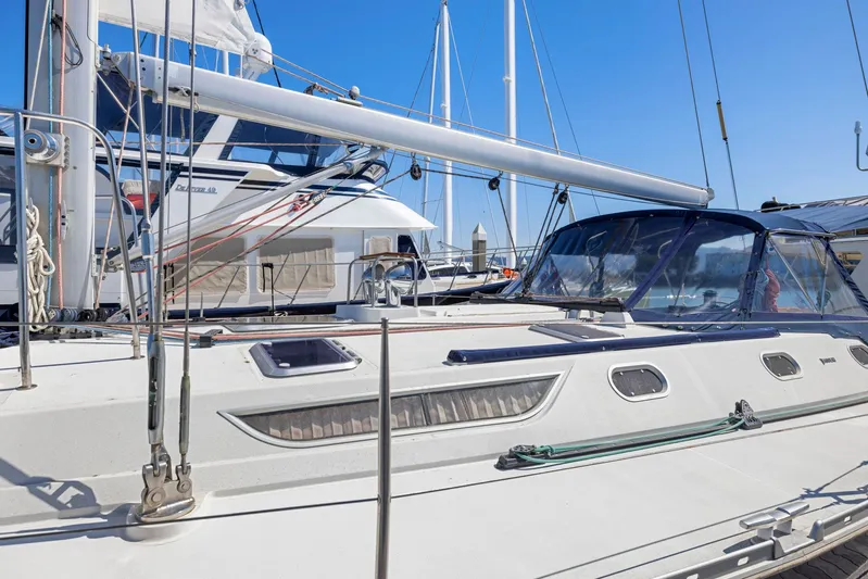Crazy Horse Yacht Photos Pics 2001 Jeanneau Sun Odyssey 52.2 sailboat docked at marina under clear blue sky.