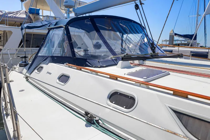 Crazy Horse Yacht Photos Pics Jeanneau Sun Odyssey 52.2 sailboat, 2001 model, docked with blue canopy and sleek design.