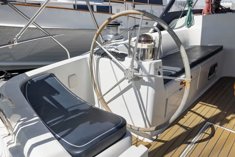 Crazy Horse Yacht Photos Pics Cockpit of 2001 Jeanneau Sun Odyssey 52.2 sailboat with steering wheel and seating.