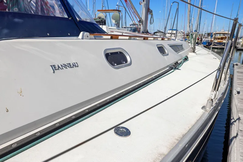 Crazy Horse Yacht Photos Pics 2001 Jeanneau Sun Odyssey 52.2 sailboat docked at marina, side view.