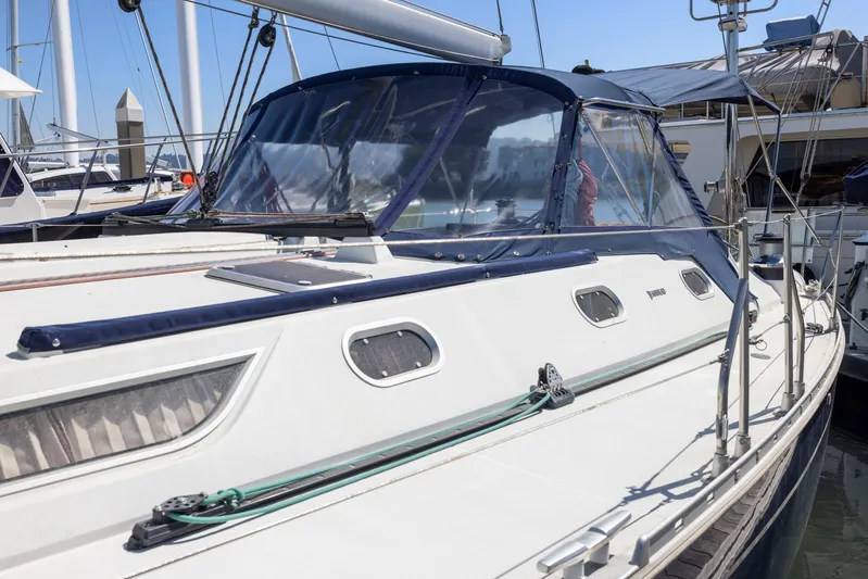 Crazy Horse Yacht Photos Pics Jeanneau Sun Odyssey 52.2 sailboat, 2001 model, docked at marina under clear blue sky.