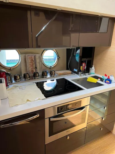  Yacht Photos Pics Modern kitchen in 2012 Cranchi Sixty 6 Fly Yacht with sleek appliances and porthole windows.