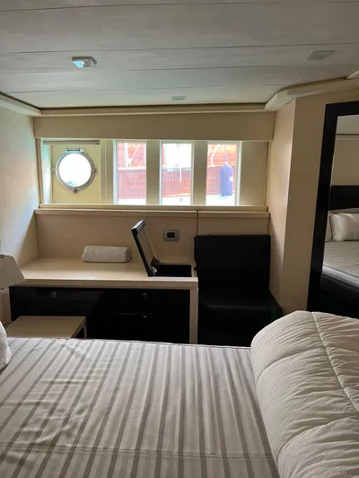  Yacht Photos Pics Luxurious cabin interior of 2012 Cranchi Sixty 6 Fly Yacht with porthole and modern furnishings.