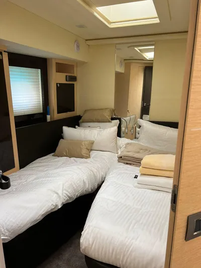  Yacht Photos Pics Luxurious bedroom interior of 2012 Cranchi Sixty 6 Fly Yacht with twin beds and modern decor.