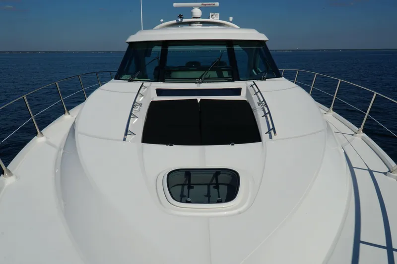  Yacht Photos Pics 2014 Sea Ray 540 Sundancer yacht on calm blue water, showcasing sleek design and spacious deck.