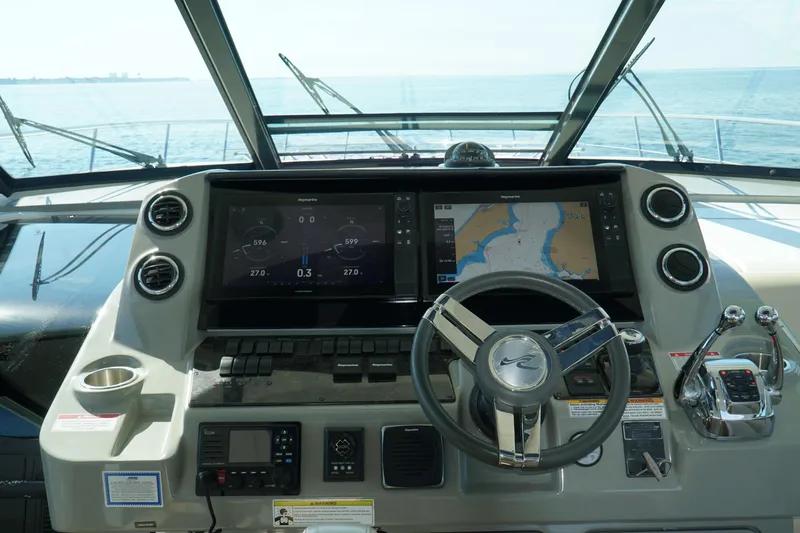 Yacht Photos Pics Cockpit of 2014 Sea Ray 540 Sundancer with navigation screens and steering wheel.