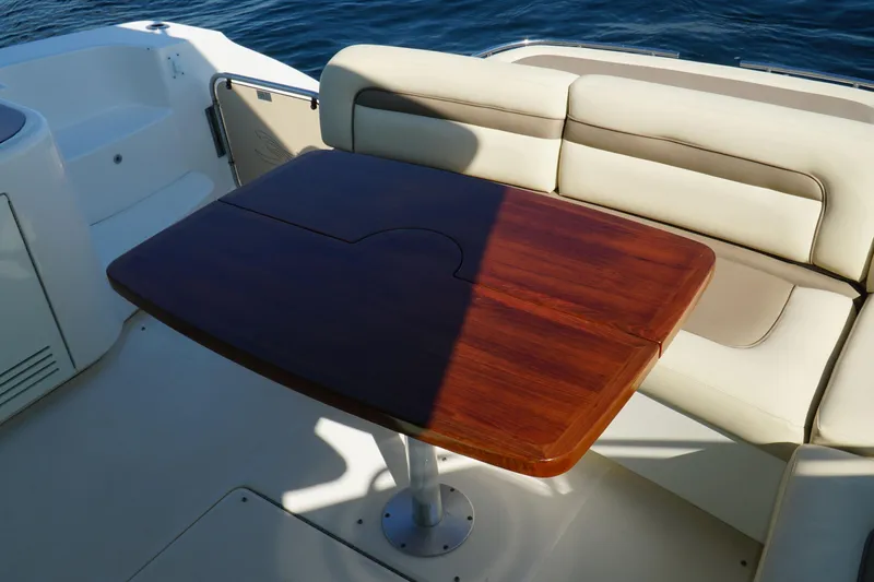  Yacht Photos Pics Luxury seating area on 2014 Sea Ray 540 Sundancer yacht with wooden table.