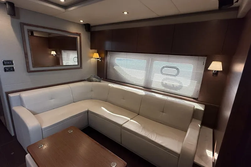  Yacht Photos Pics Luxurious interior of 2014 Sea Ray 540 Sundancer yacht with white leather seating.