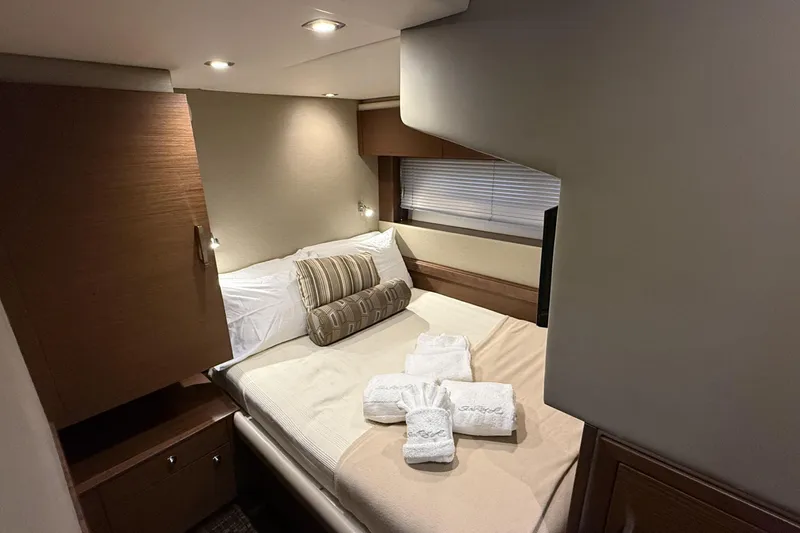  Yacht Photos Pics Luxurious cabin interior of 2014 Sea Ray 540 Sundancer yacht with cozy bed and elegant decor.