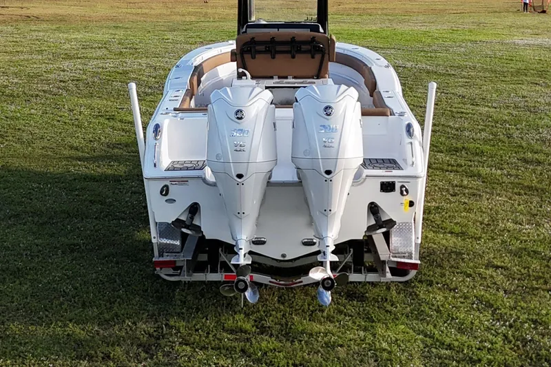  Yacht Photos Pics 2023 Seahunt 30 GameFish Coffin Box boat with dual outboard engines on grass.