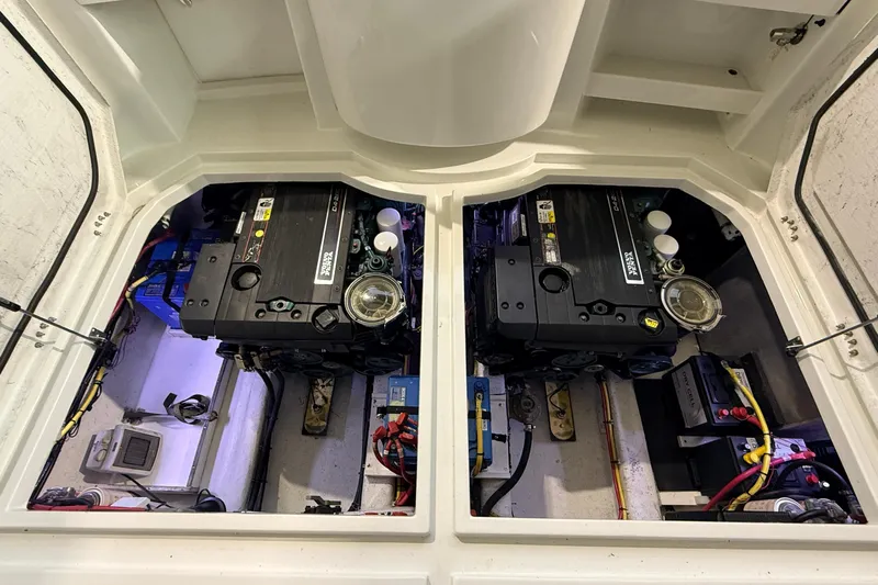 Kapalua Yacht Photos Pics Engine compartment of a 2013 Ocean Sport Roamer 33, showcasing dual engines and wiring.