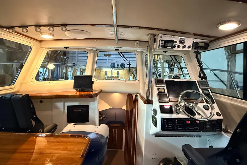 Kapalua Yacht Photos Pics Interior of 2013 Ocean Sport Roamer 33 boat, featuring helm and navigation equipment.
