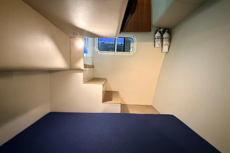 Kapalua Yacht Photos Pics Interior cabin of 2013 Ocean Sport Roamer 33 with stairs and window.
