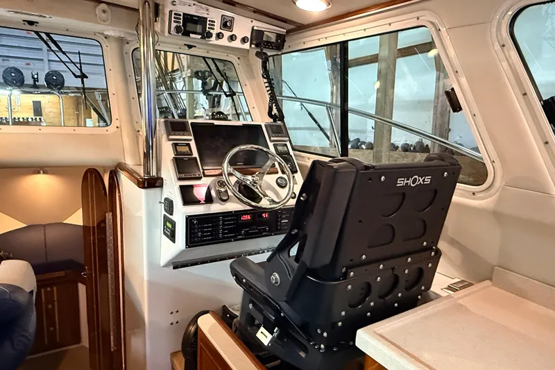 Kapalua Yacht Photos Pics Interior of 2013 Ocean Sport Roamer 33 boat, featuring helm and navigation equipment.