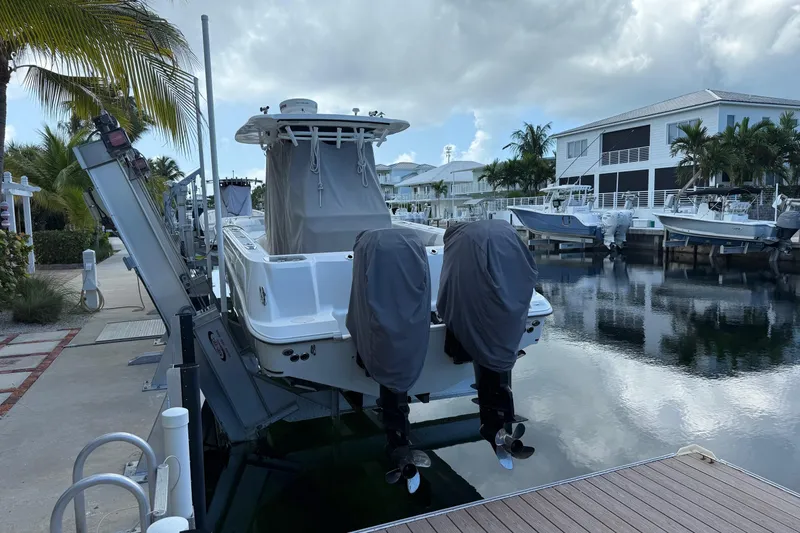  Yacht Photos Pics 2016 Boston Whaler 320 Outrage docked, covered engines, tropical marina setting.