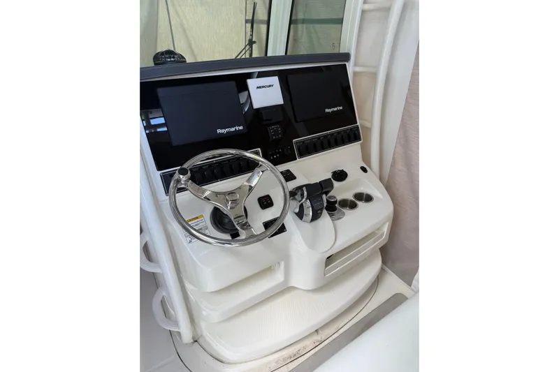  Yacht Photos Pics 2016 Boston Whaler 320 Outrage helm with Raymarine displays and steering wheel.