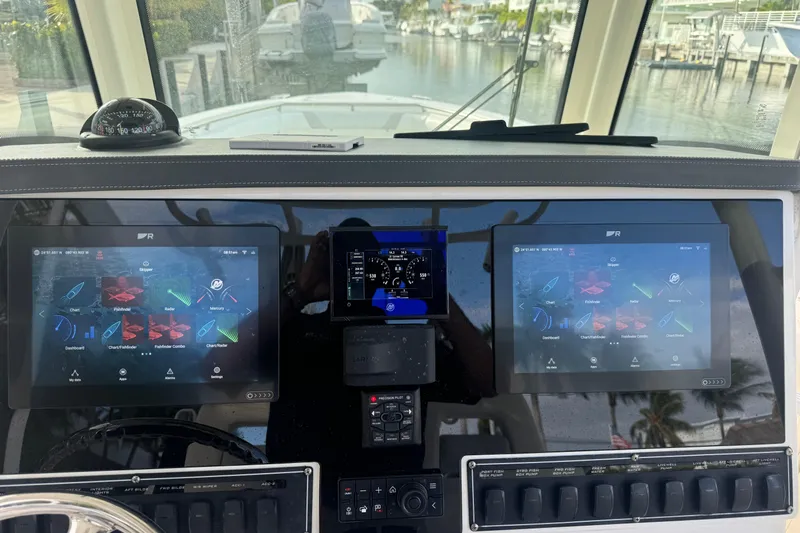  Yacht Photos Pics Helm of 2016 Boston Whaler 320 Outrage with dual navigation screens and compass.