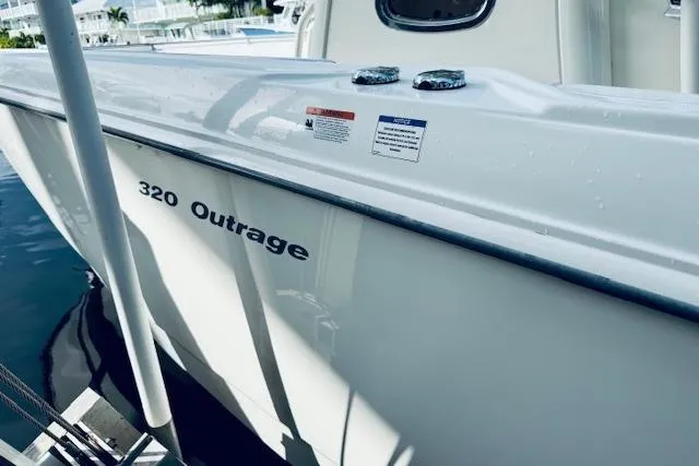  Yacht Photos Pics 2016 Boston Whaler 320 Outrage boat docked, showcasing sleek white hull design.