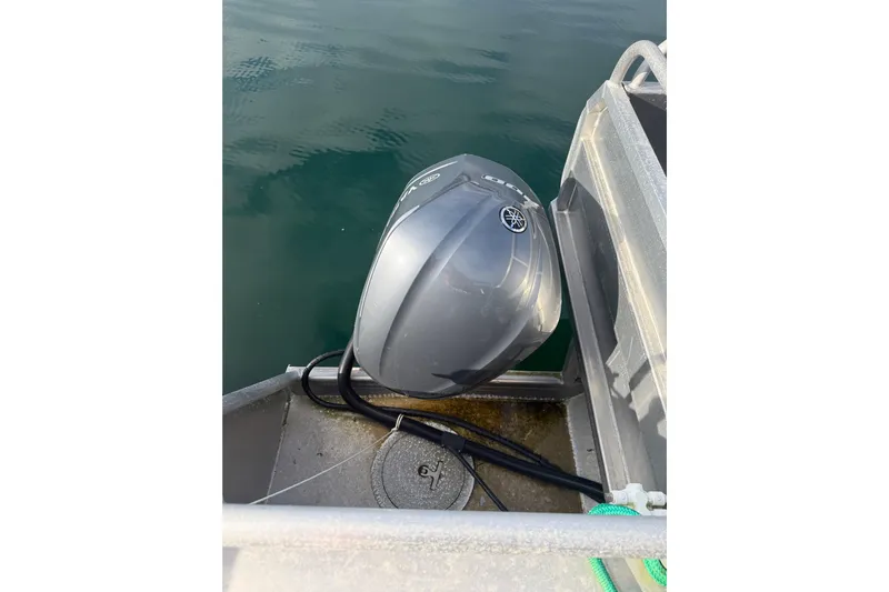 C Lady Yacht Photos Pics Outboard motor on a 2020 Armstrong Marine 35 boat, docked on calm water.