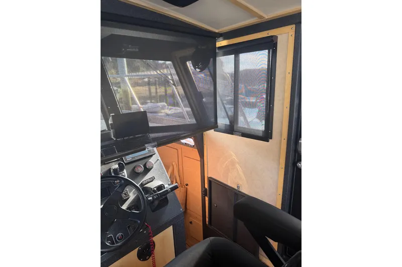 C Lady Yacht Photos Pics Interior view of 2020 Armstrong Marine 35 boat cockpit with steering wheel and controls.