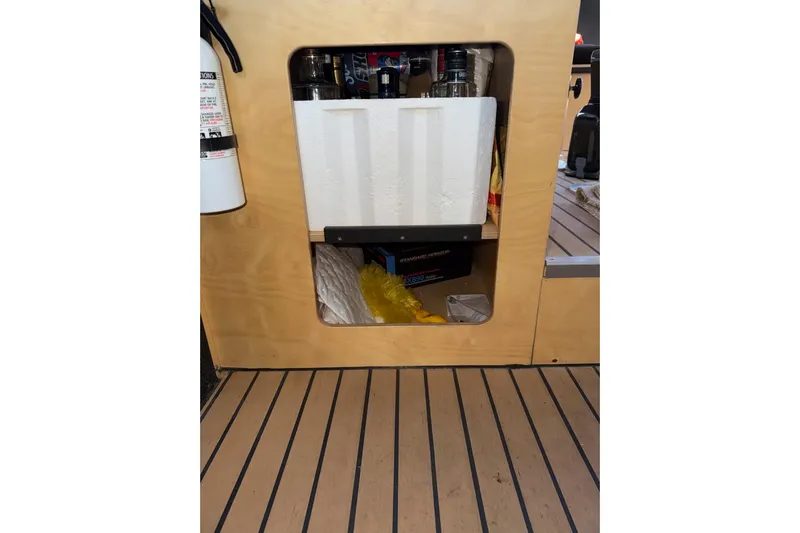 C Lady Yacht Photos Pics Interior storage compartment of a 2020 Armstrong Marine 35 boat with various items.