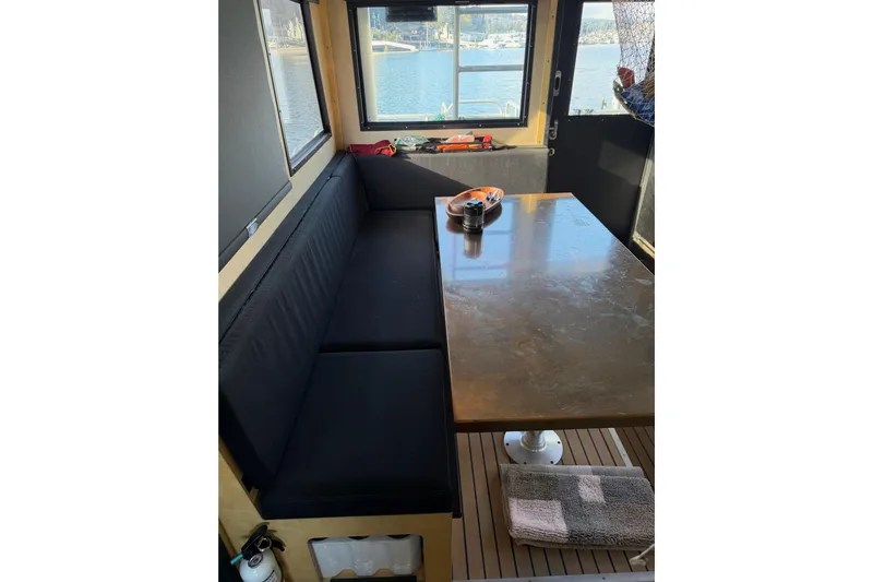 C Lady Yacht Photos Pics Interior of 2020 Armstrong Marine 35 boat with table and seating area.