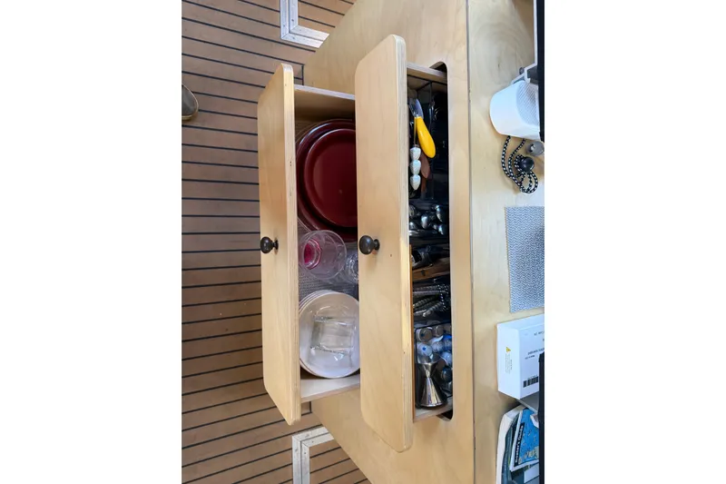 C Lady Yacht Photos Pics Open wooden cabinet with kitchenware and tools on Armstrong Marine 35, 2020 model.