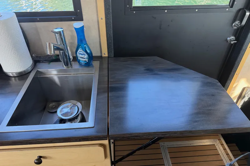 C Lady Yacht Photos Pics Modern kitchen sink area in 2020 Armstrong Marine 35 boat, featuring faucet and cleaning supplies.