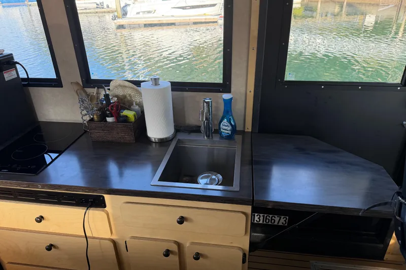 C Lady Yacht Photos Pics Modern kitchen area on a 2020 Armstrong Marine 35 boat with sink and utensils.