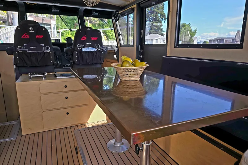C Lady Yacht Photos Pics Interior of 2020 Armstrong Marine 35 boat with seating and table.
