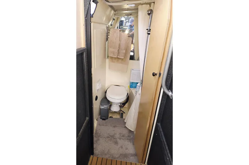 C Lady Yacht Photos Pics Compact bathroom inside 2020 Armstrong Marine 35 boat, featuring toilet, shower, and towel rack.
