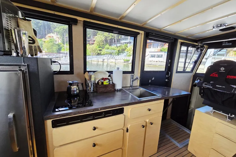 C Lady Yacht Photos Pics Interior of 2020 Armstrong Marine 35 boat with kitchenette and captain's chair.