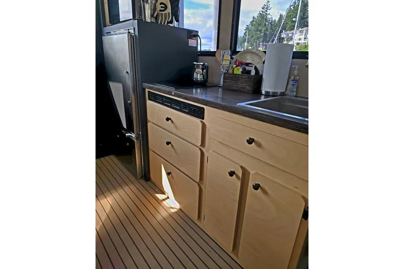 C Lady Yacht Photos Pics 2020 Armstrong Marine 35 interior kitchen with wooden cabinets and modern appliances.